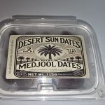 Sealed 2 lb container of Desert Sun Dates California Medjool dates with the farm label facing forward