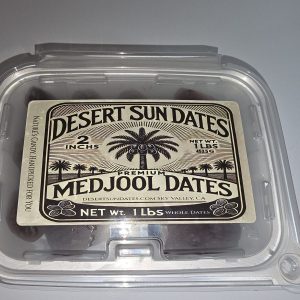 Medjool date palm trees growing in sandy desert soil at Desert Sun Dates farm in Sky Valley California